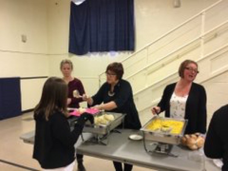 Volunteers helping serve lunch.