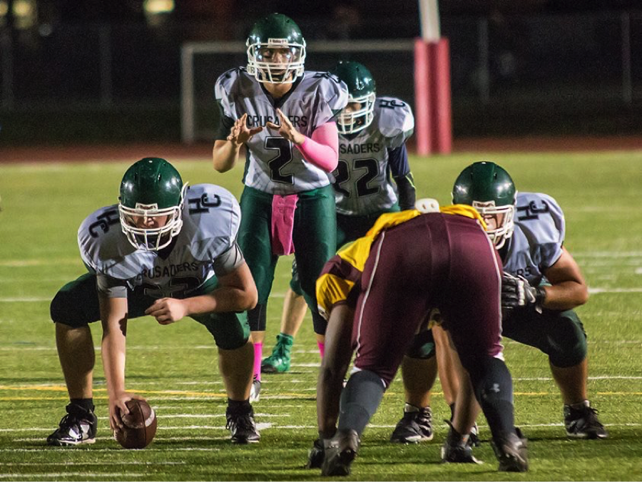 Players read to snap the ball.