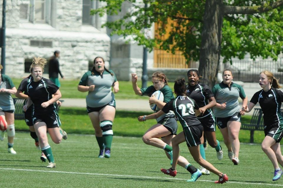 Rugby players running with ball