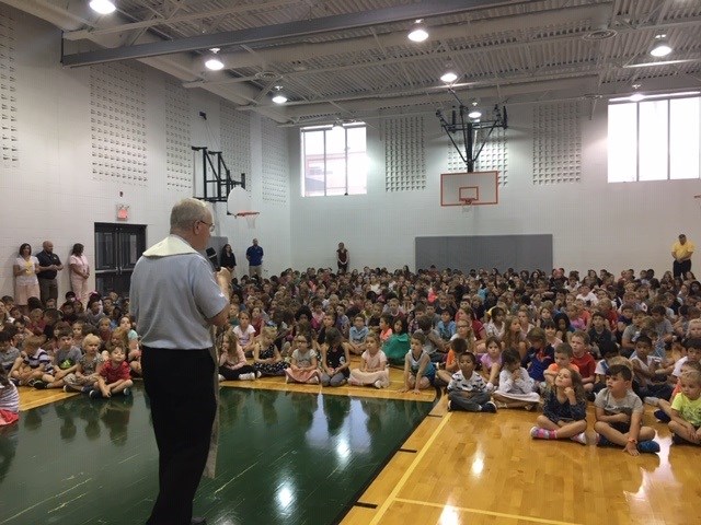 Preist blessing the school.