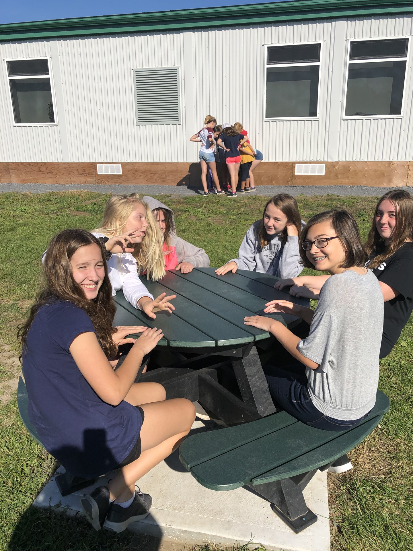 Students sitting together in the sunshine.