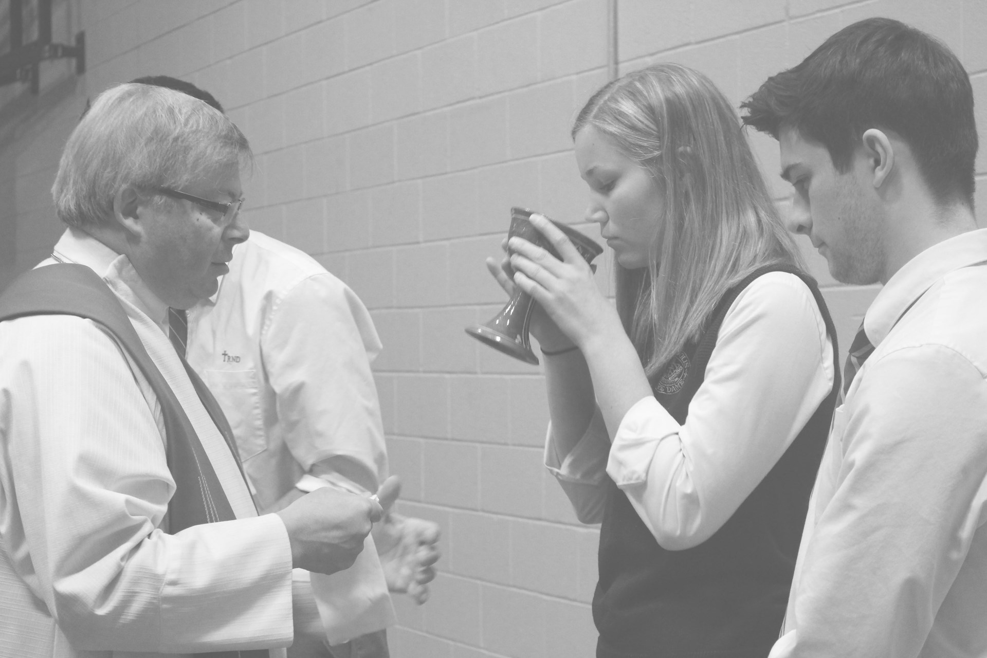 Student receiving wine at mass.