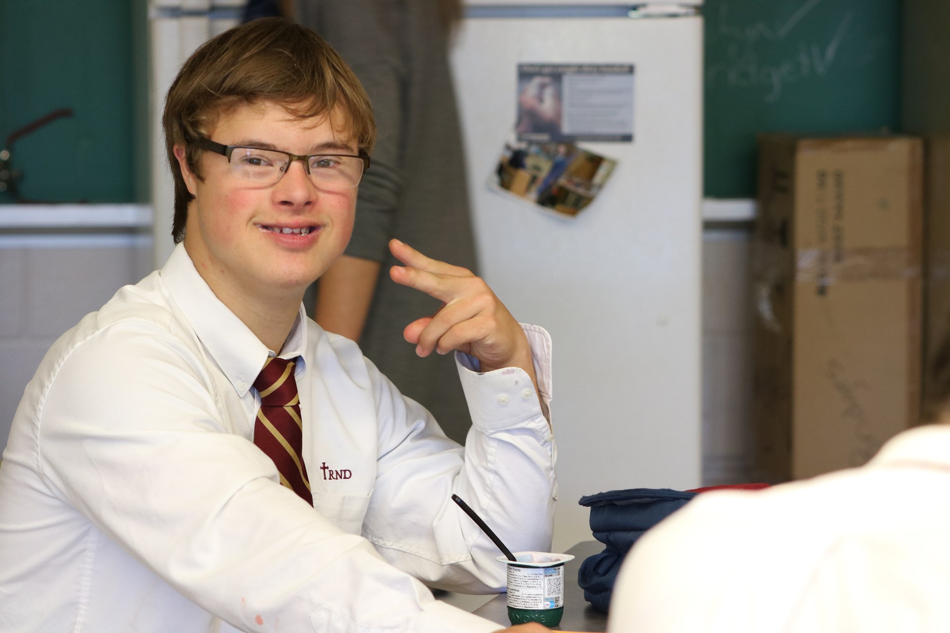 Student making peace sign.