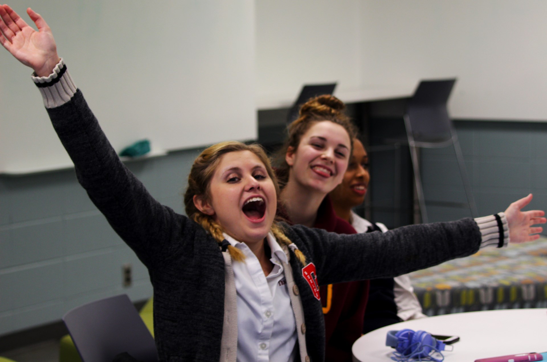 Student shouting and streching out her arms.